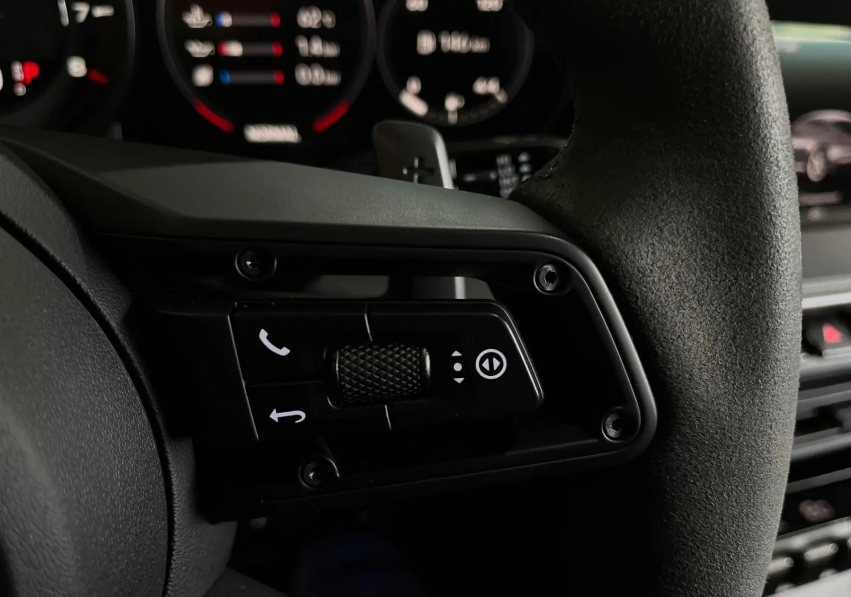 Gros plan sur le bouton multifonction du volant en Alcantara de la Porsche 911 Carrera S argent GT de 2019.