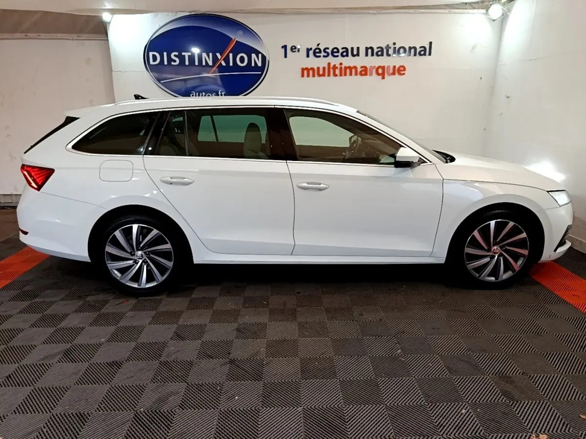 Profil droit d'une Skoda Octavia break blanche 2022, avec jantes alliage et feux arrière LED distinctifs.
