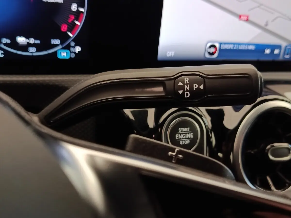 Gros plan sur la commande de boîte automatique et bouton start/stop dans l'habitacle noir du Mercedes Classe A 250 e Hybrid.
