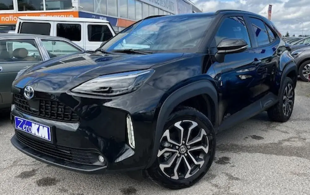 Toyota Yaris Cross 130H Design 2025 noir vue 3/4 avant droit en showroom avec jantes alliage distinctives