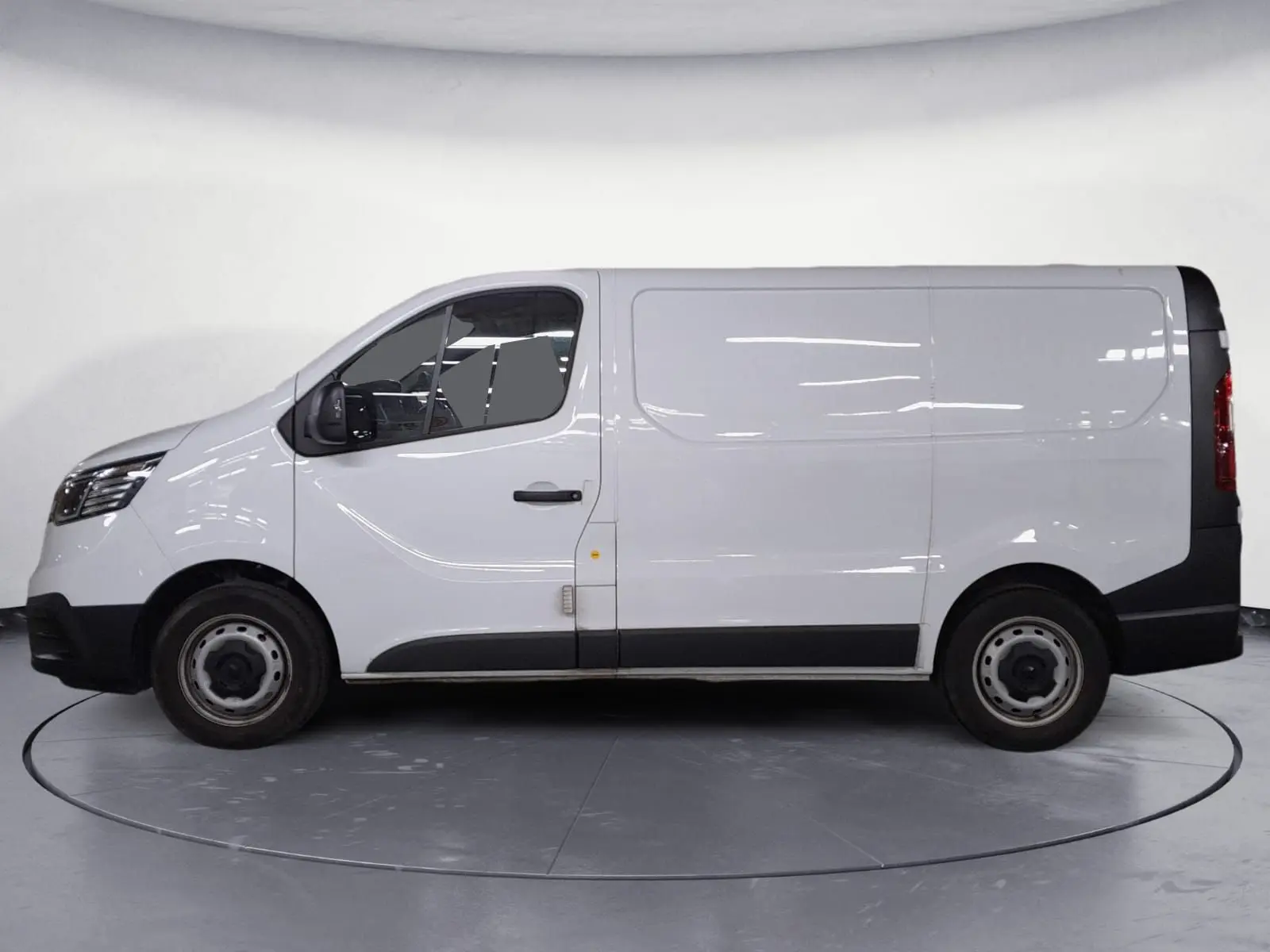 Vue de profil côté gauche d’un Renault Trafic Fourgon blanc minéral 2024 avec protections noires sur les bas de caisse.