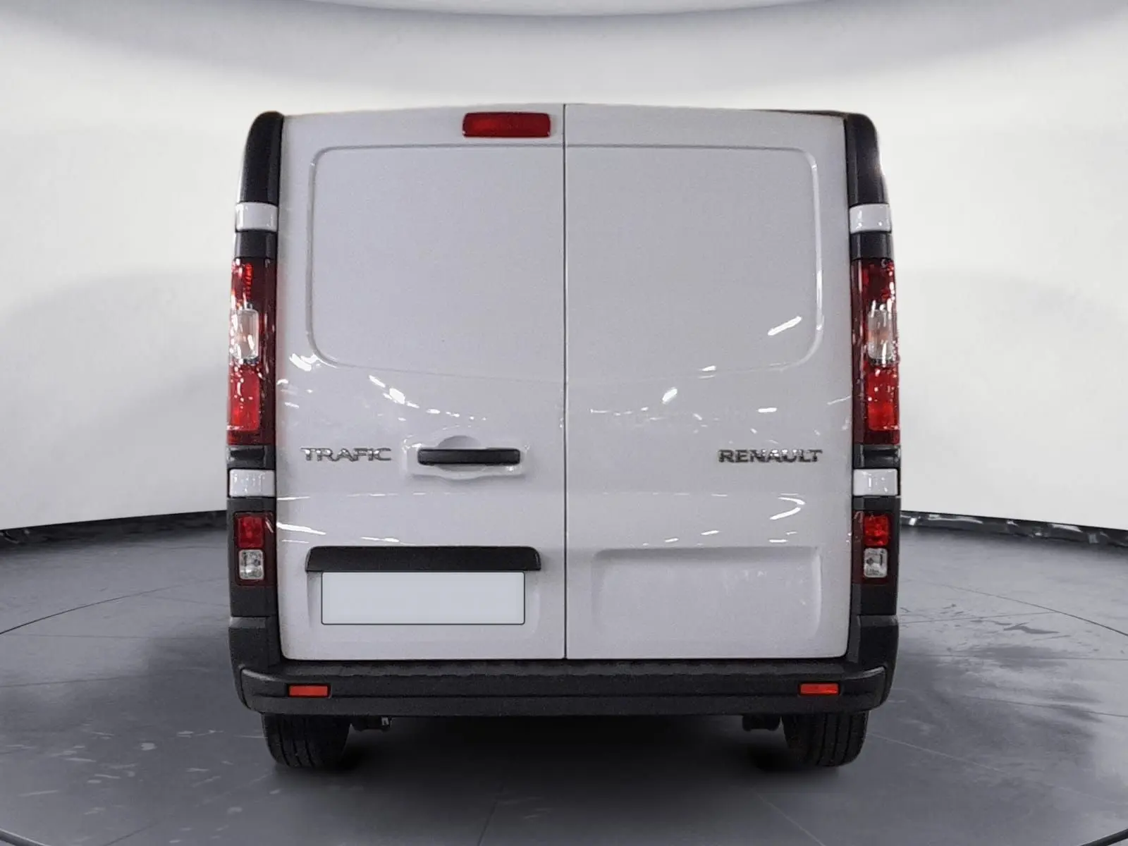 Vue arrière d’un Renault Trafic Fourgon blanc minéral 2024 avec portes battantes et feux verticaux rouges.