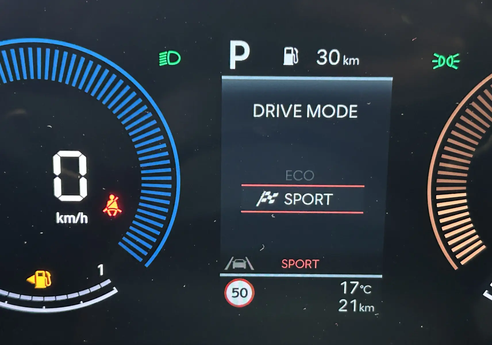 Affichage numérique du tableau de bord du Hyundai Tucson hybride 2025 montrant le mode de conduite Sport et l'autonomie restante.