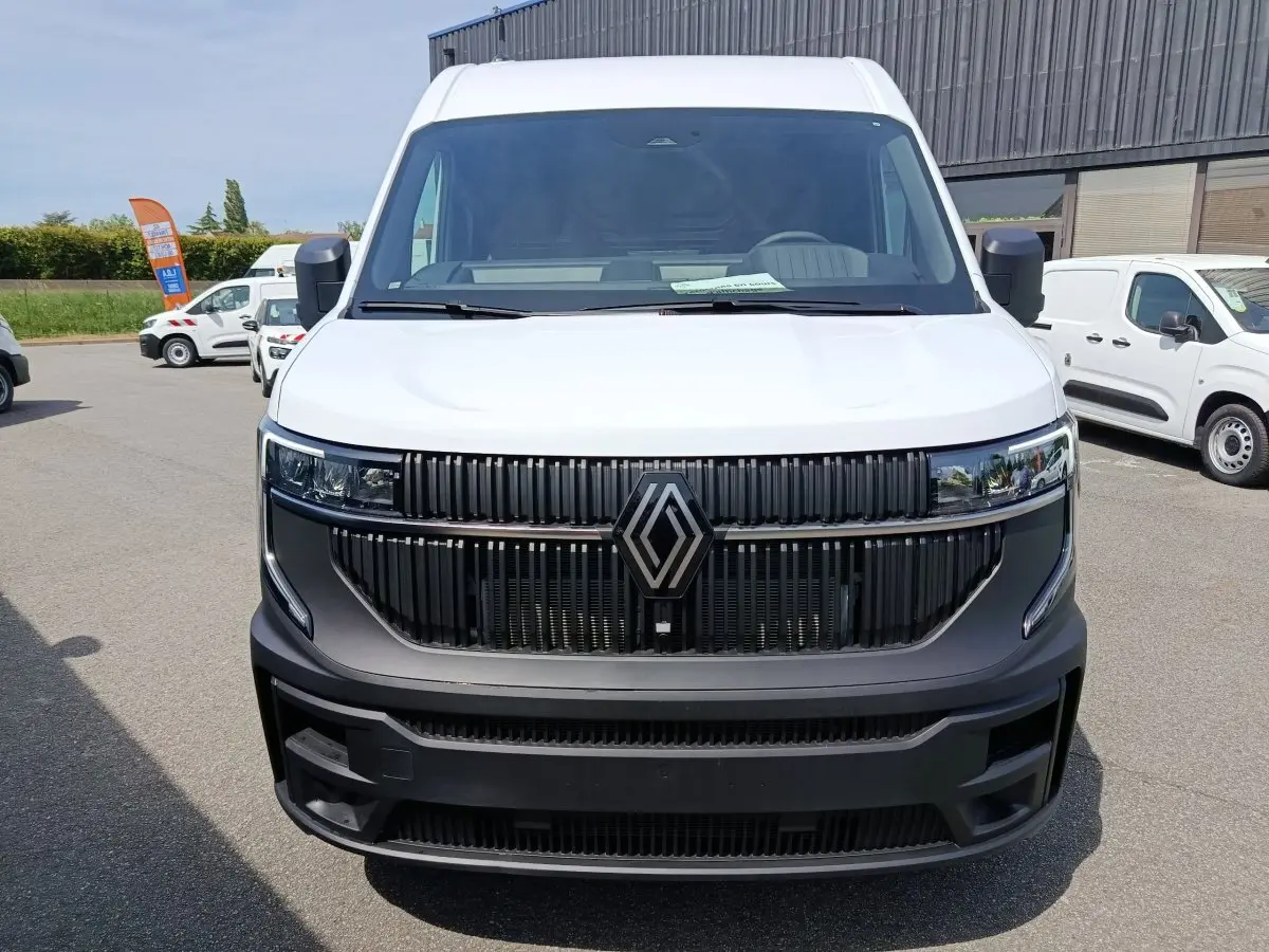 Vue frontale d’un Renault Master blanc avec calandre noire et grand logo Renault central.