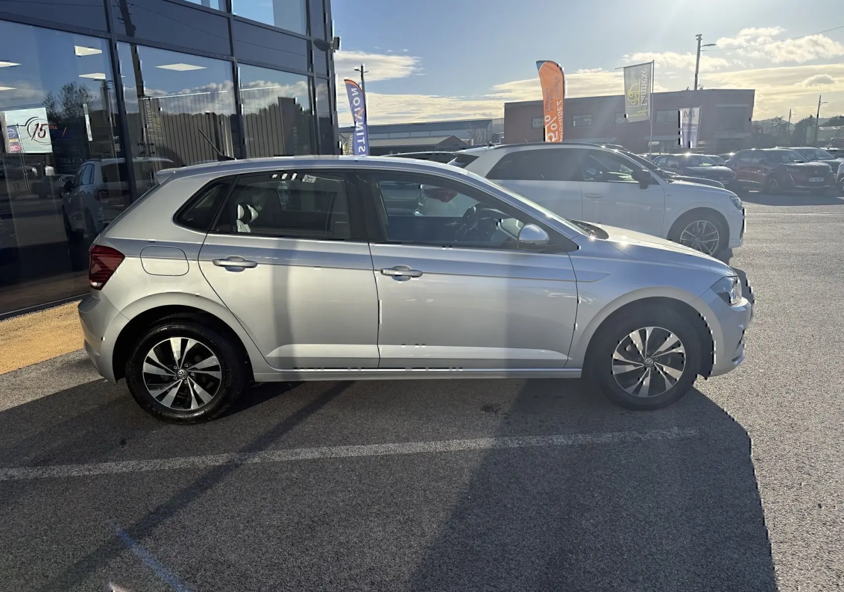 Volkswagen Polo 1.0 TSI 95 Lounge Business gris métal vue de profil côté gauche en extérieur au soleil.