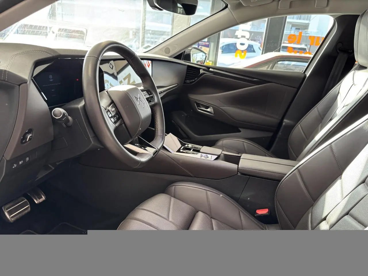 Vue intérieure côté conducteur du DS4 E-Tense 2023, avec sièges cuir brun Criollo et tableau de bord moderne.