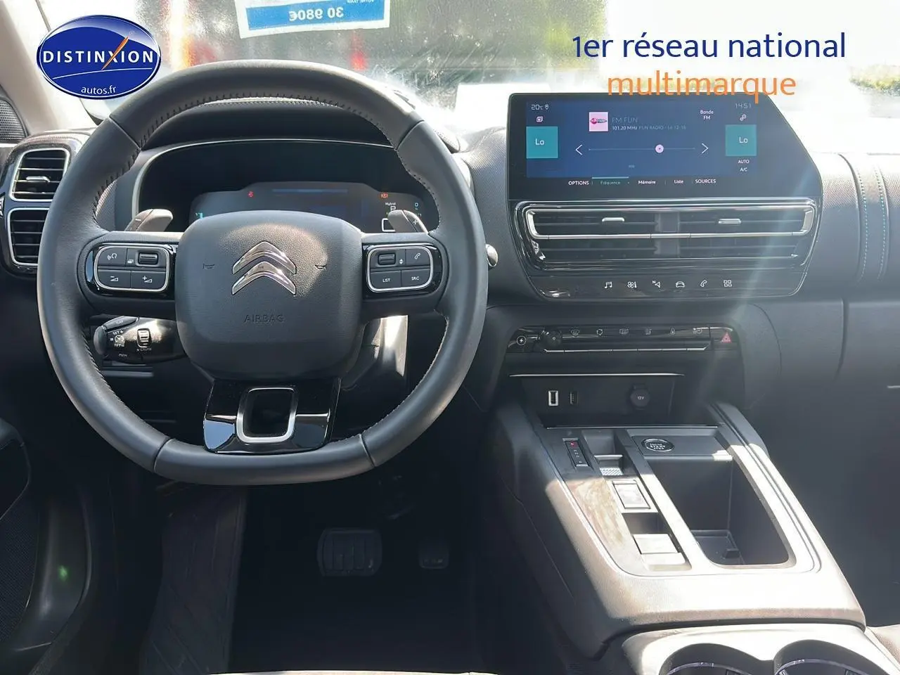 Vue intérieure centrée sur le volant cuir multifonction et l’écran tactile du tableau de bord du Citroën C5 Aircross 2024.