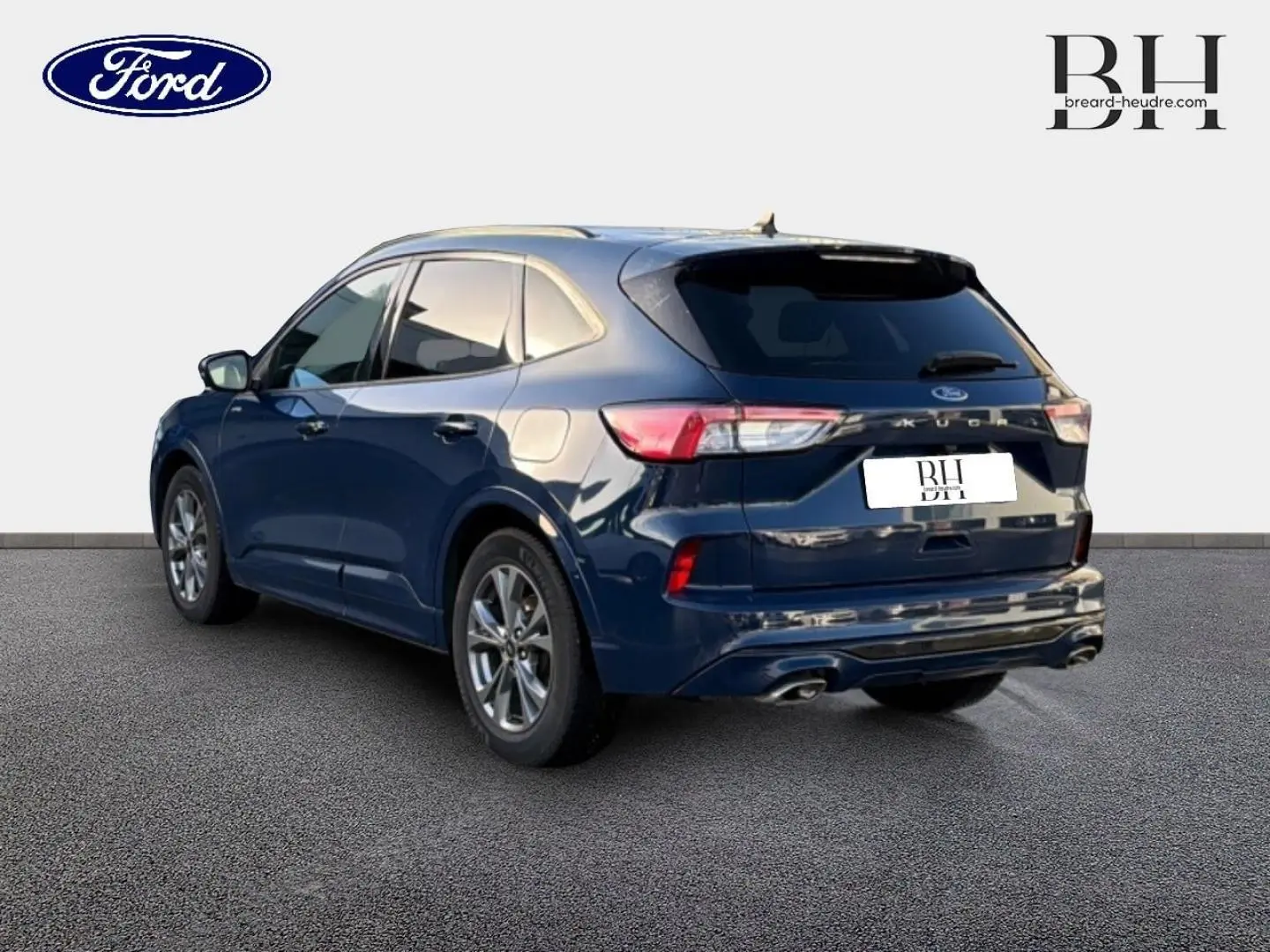 Ford Kuga bleu Abysse en 3/4 arrière droit, avec feux LED et double sortie d’échappement visible sur fond neutre.