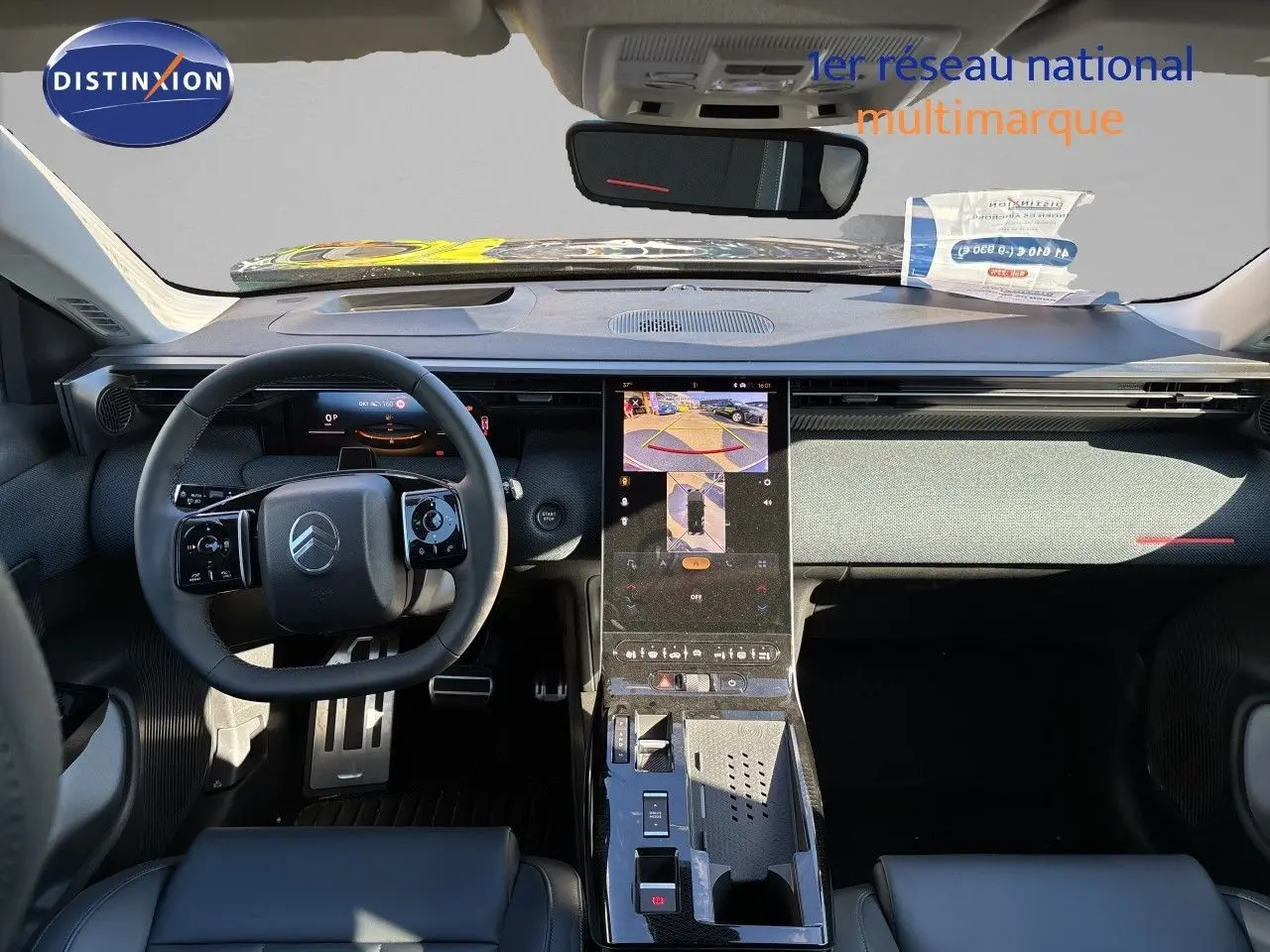 Vue intérieure avant du Citroën C5 Aircross Hybrid 2026, tableau de bord moderne avec écran central tactile et volant compact noir.