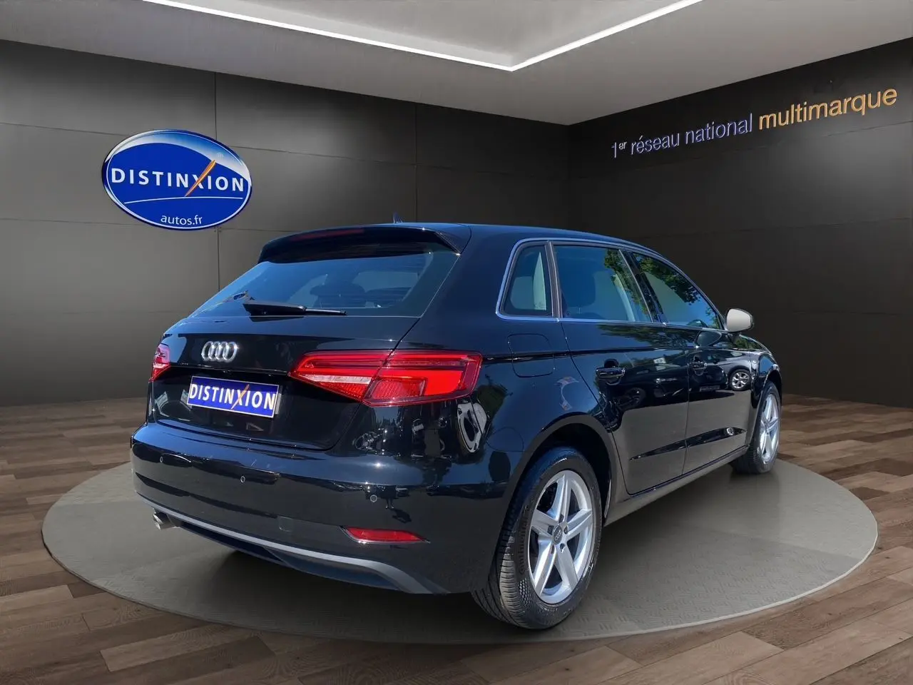 Audi A3 Sportback noir vue 3/4 arrière droit, feux arrière LED et jantes alliage 5 branches visibles.