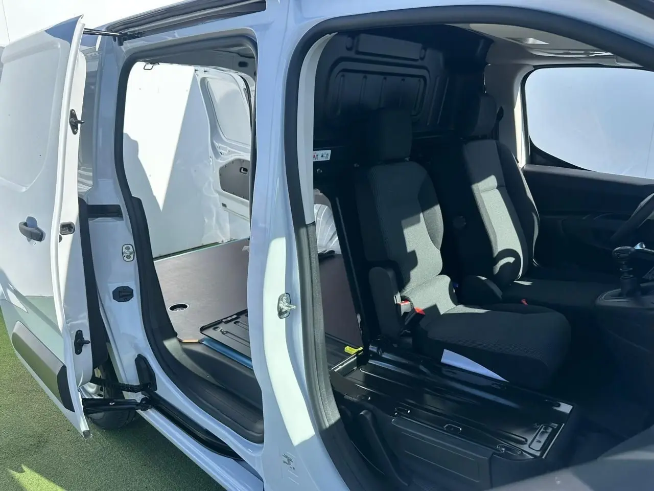 Vue côté gauche du Citroën Berlingo blanc Icy avec portes ouvertes montrant l’habitacle et l’espace de chargement.