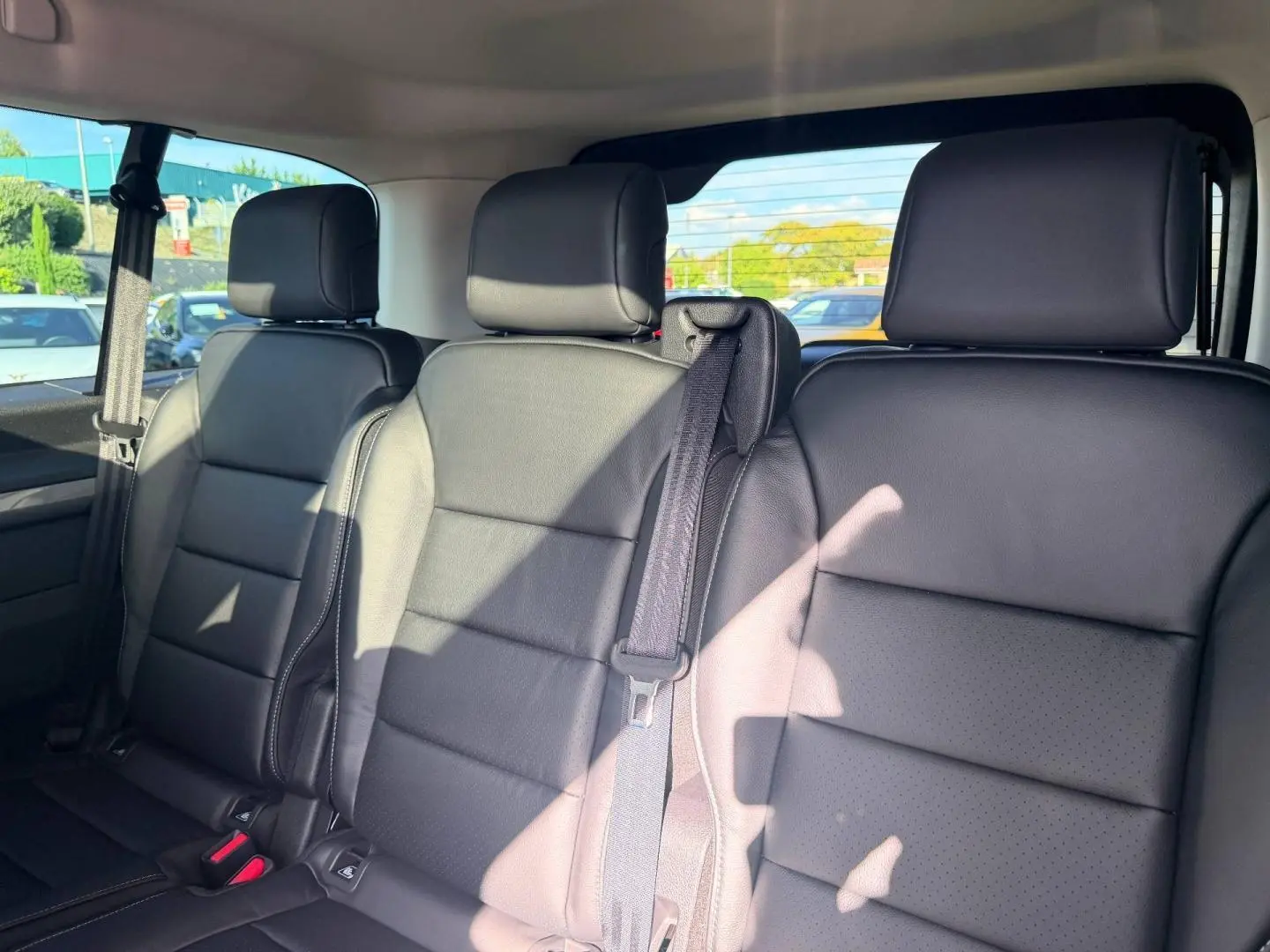 Vue intérieure de la 3ème banquette en cuir noir du Citroën Spacetourer XL, avec appuie-têtes et ceintures visibles.