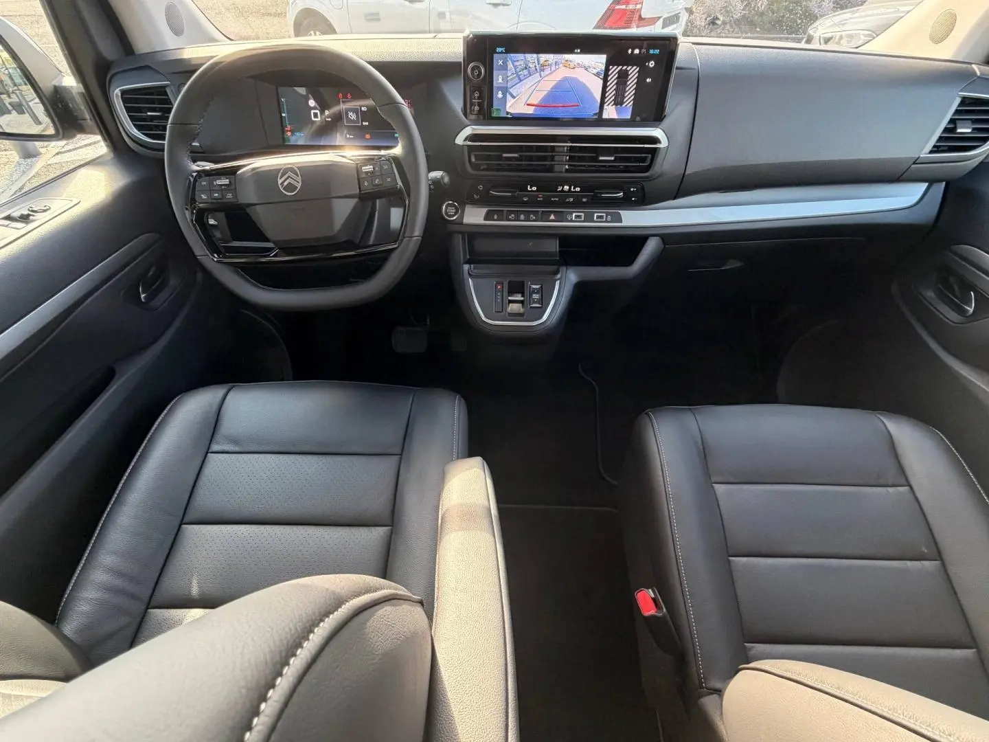 Vue intérieure avant du Citroën Spacetourer XL noir, montrant le tableau de bord et les sièges en cuir noir.