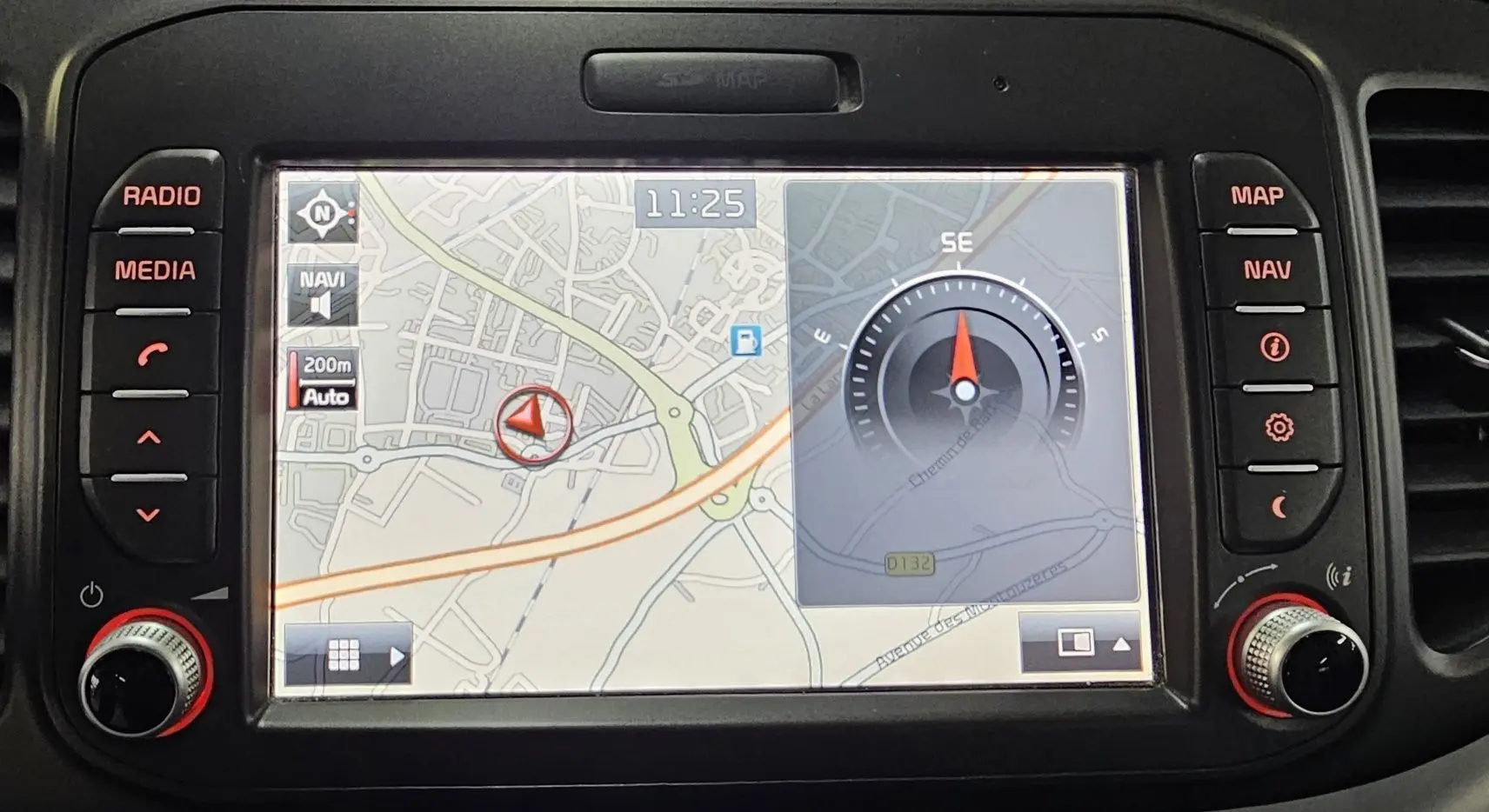Écran GPS intégré de la Kia Picanto II 2016 montrant une carte et une boussole, avec commandes autour de l'écran.