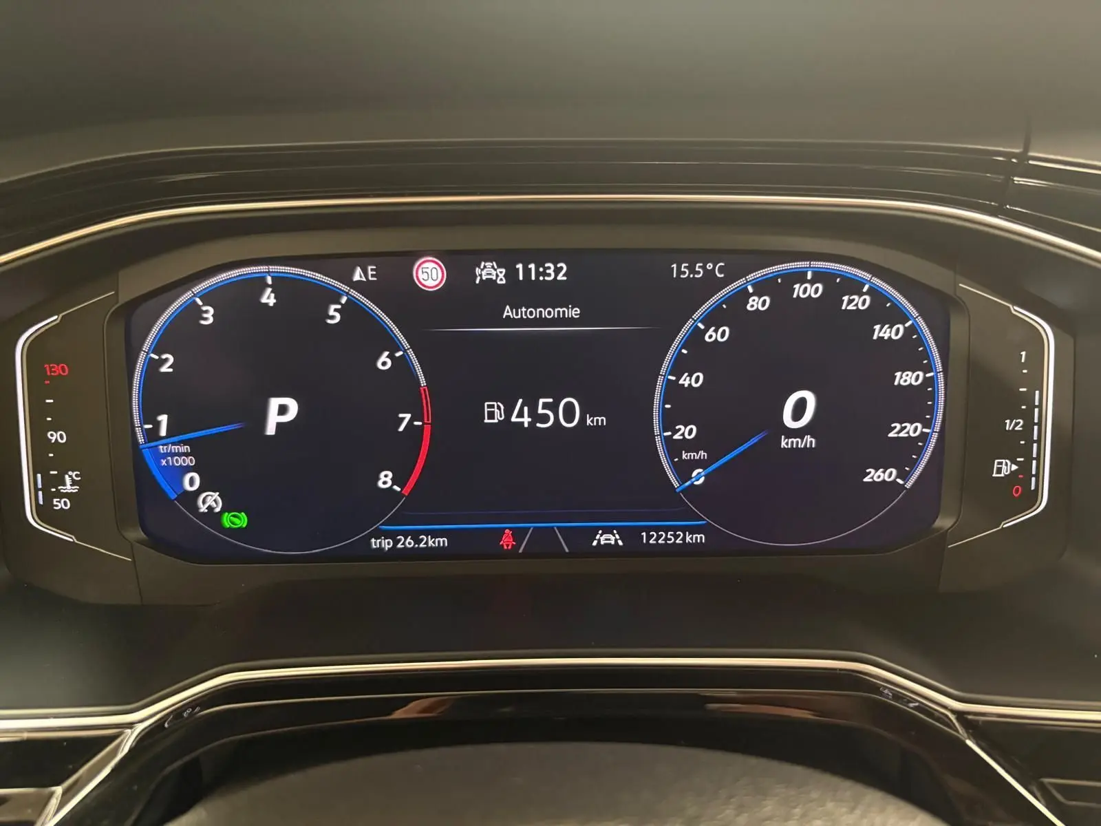 Tableau de bord numérique du Volkswagen Taigo 2024 affichant vitesse, régime moteur et autonomie, vue frontale rapprochée.