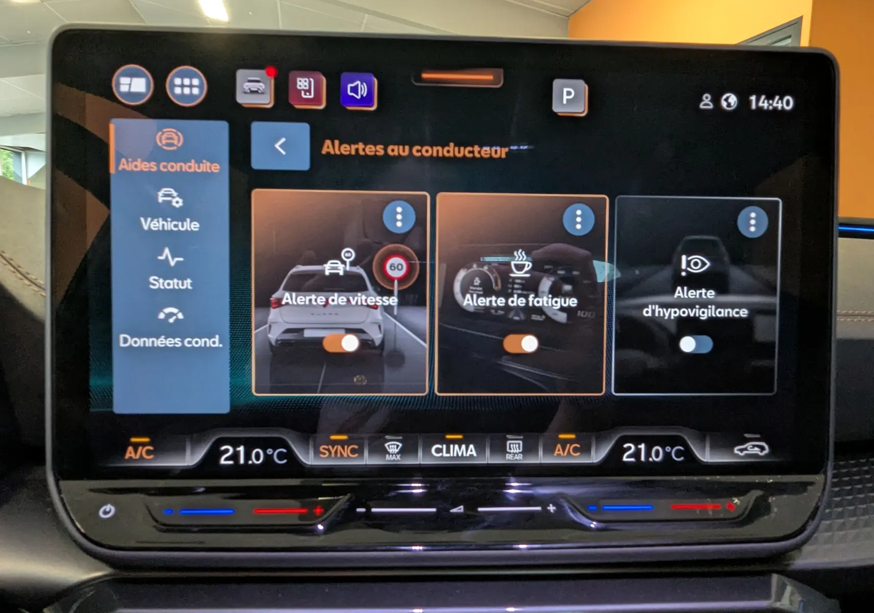 Écran tactile intérieur du CUPRA LEON ST 2025 affichant les alertes au conducteur avec commandes climatisation à 21°C.