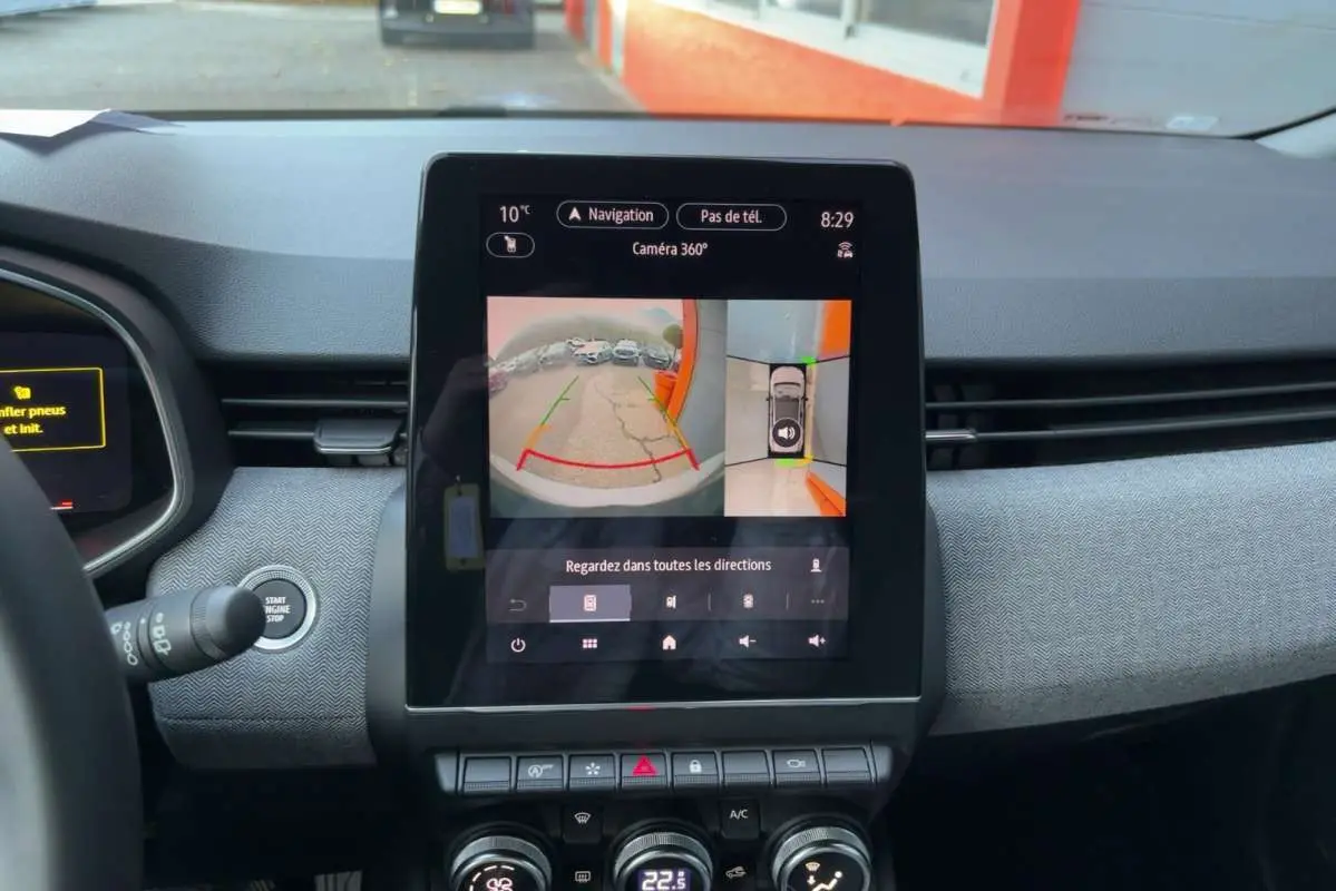 Écran central tactile affichant la caméra 360° dans l'habitacle d'une Renault Clio gris rafale, vue de face.