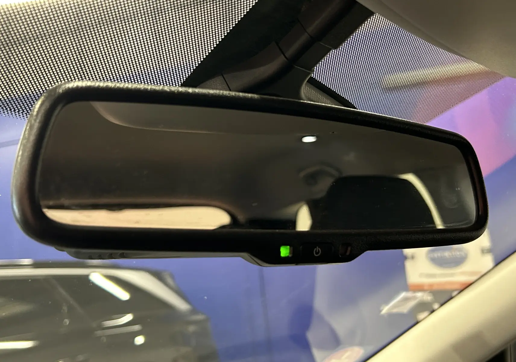 Rétroviseur intérieur avec indicateur vert allumé dans une Renault Kadjar bleu, vue depuis l'habitacle côté conducteur.