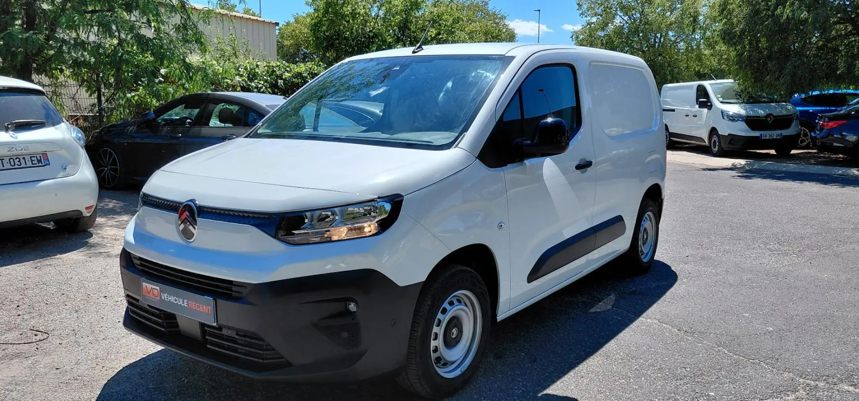 Citroën Berlingo blanc en 3/4 avant droit, fourgon compact avec pare-chocs noirs et jantes acier 15 pouces.