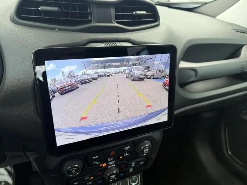Vue de l'écran central du Jeep Renegade 2024 montrant la caméra de recul avec le capot bleu métal visible en bas.