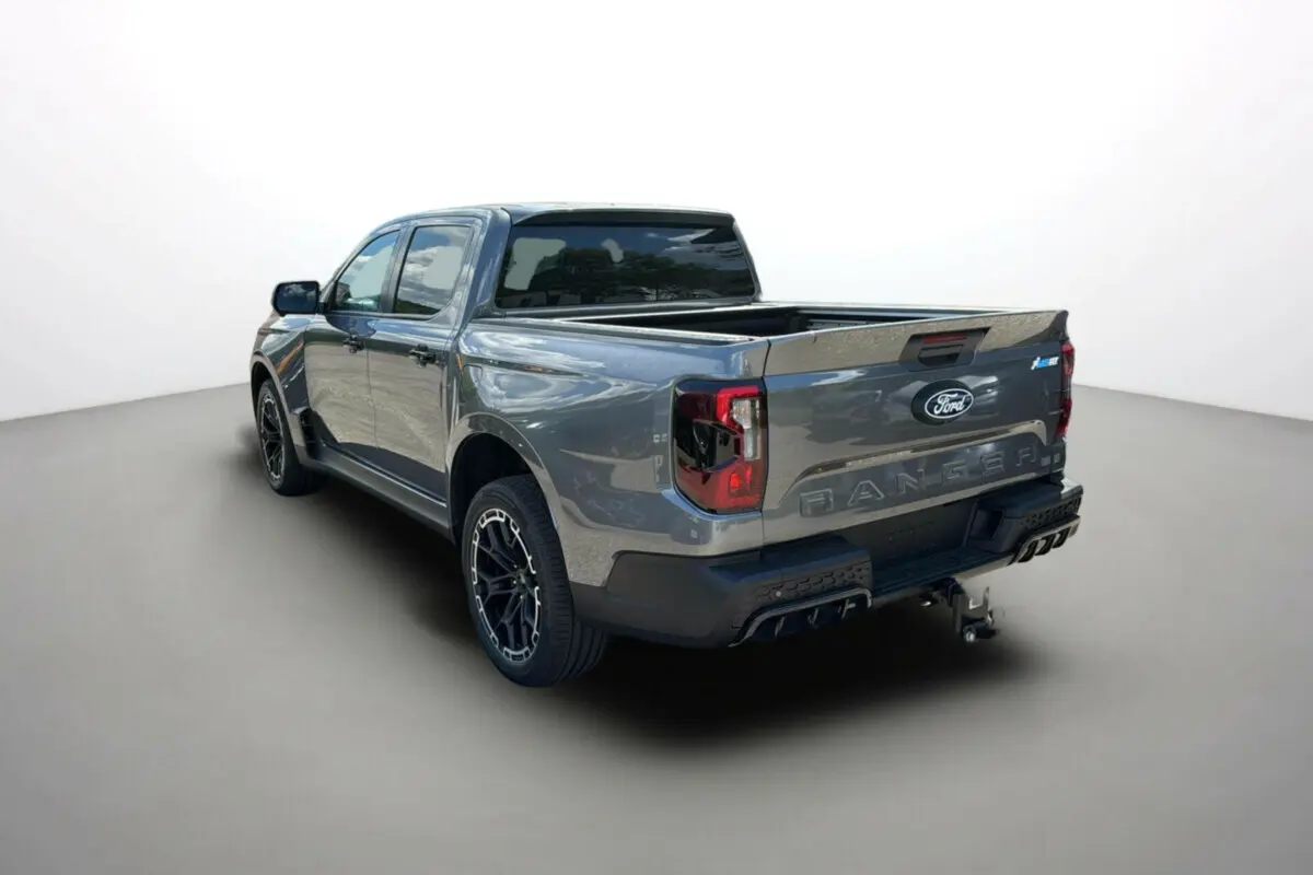 Ford Ranger 3.0 V6 gris carbone en 3/4 arrière droit, avec benne ouverte et jantes alu noires distinctives.