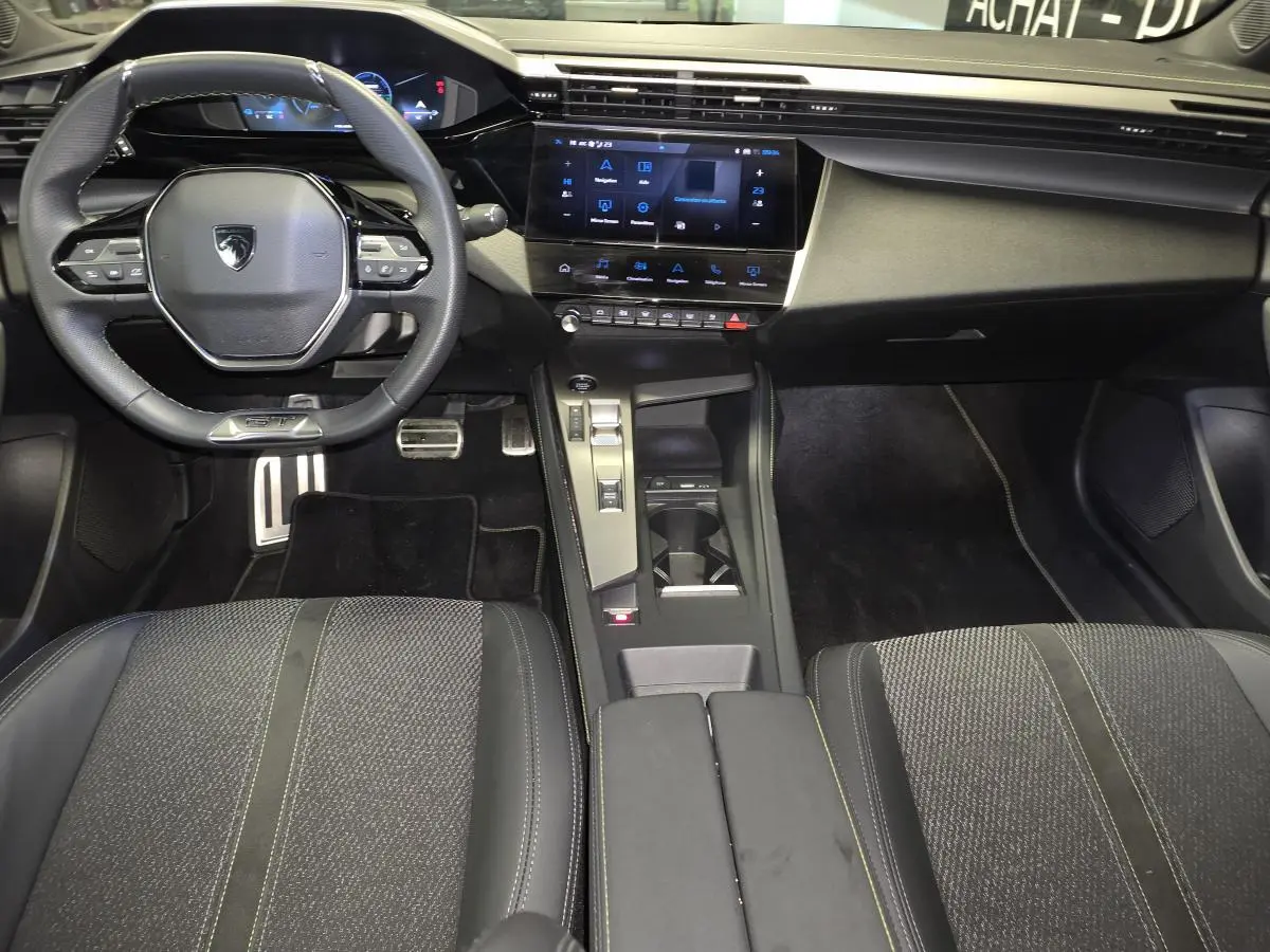 Intérieur Peugeot 408 2025 vue avant du poste de conduite avec volant GT, écran tactile 10 pouces et sellerie tissu/TEP noire.