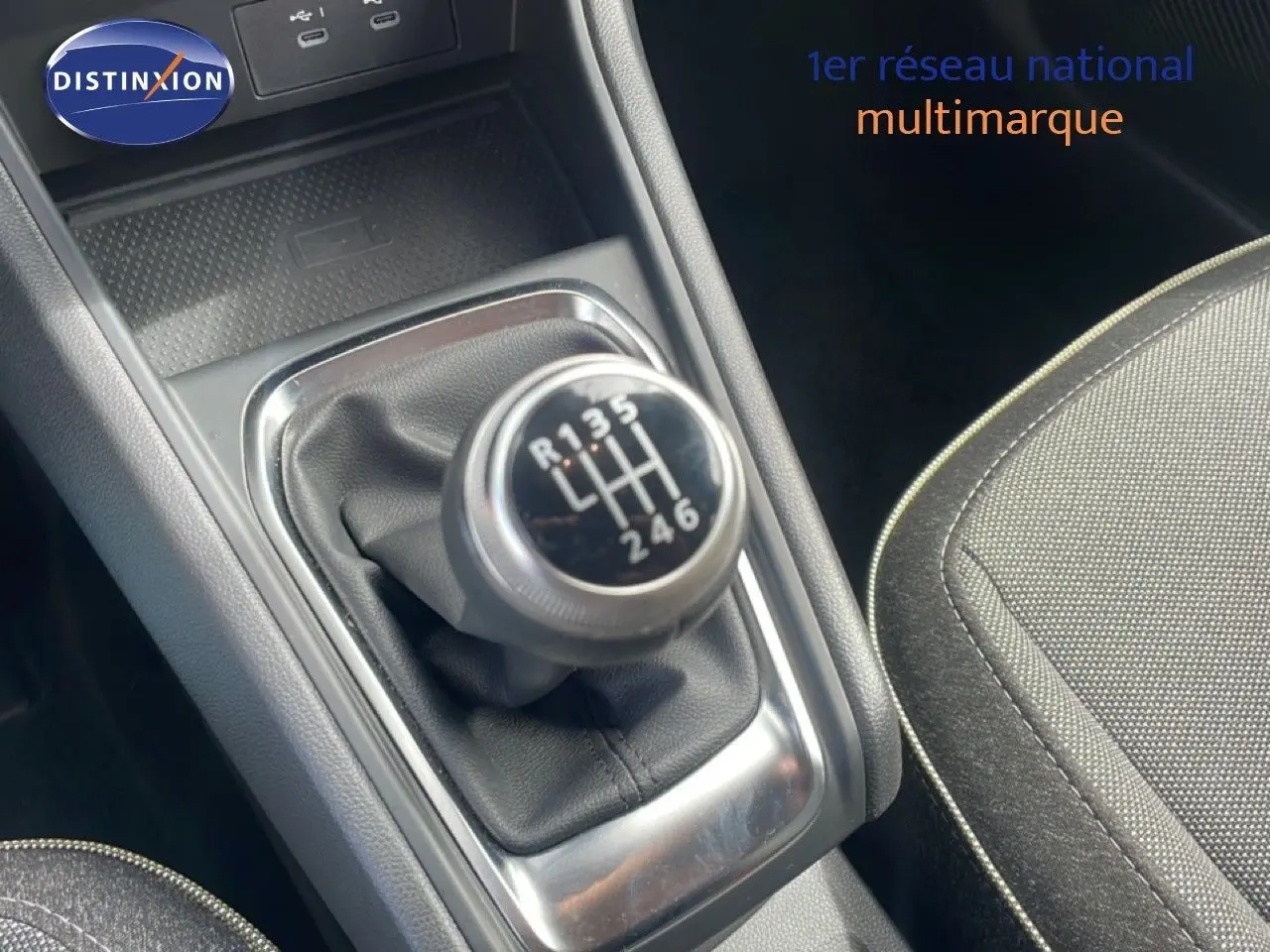 Gros plan sur le levier de vitesses manuel noir et argenté du Renault Captur 2025, avec tissu gris du siège adjacent visible.