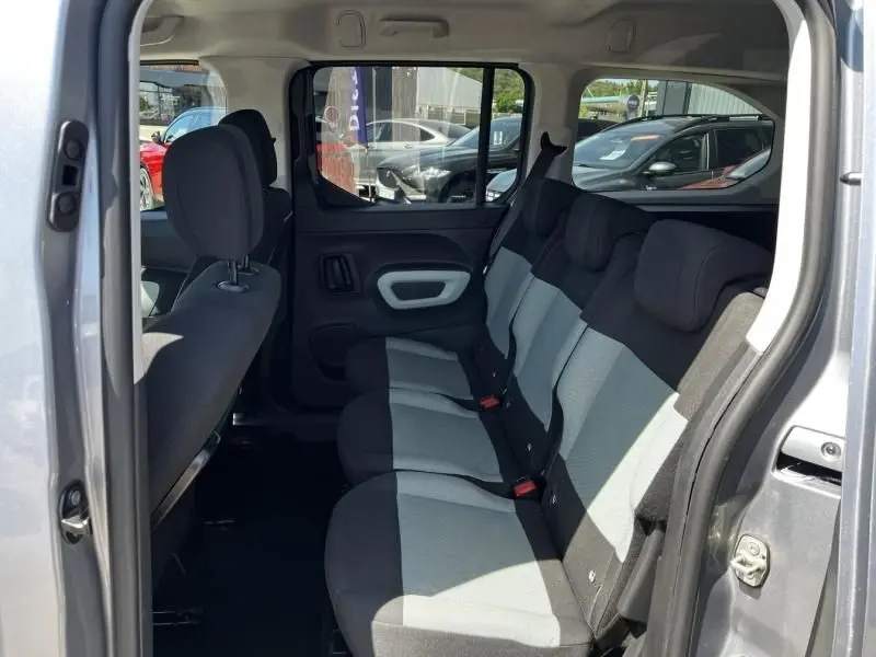 Vue intérieure côté droit du Citroën Berlingo XL gris métal 2021, montrant la banquette arrière trois places avec sièges bi-ton.