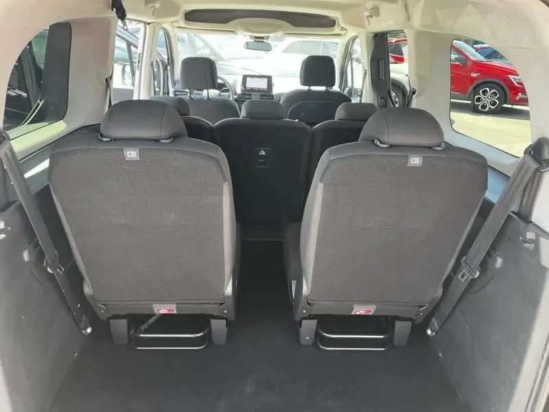Vue intérieure arrière du Citroën Berlingo XL gris métal 2021, montrant les sièges arrière et l’habitacle spacieux.