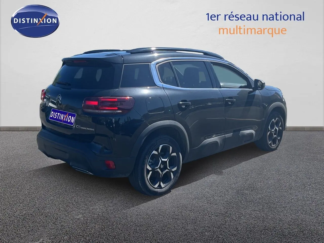 Vue 3/4 arrière droite d'un Citroën C5 Aircross noir métal, mettant en valeur ses feux arrière et ses jantes distinctives.