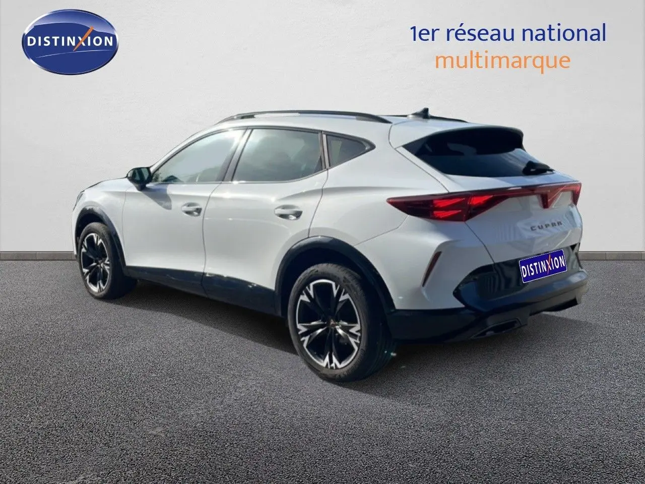Vue 3/4 arrière droite du CUPRA Formentor blanc neige métal avec jantes noires et détails sportifs visibles.