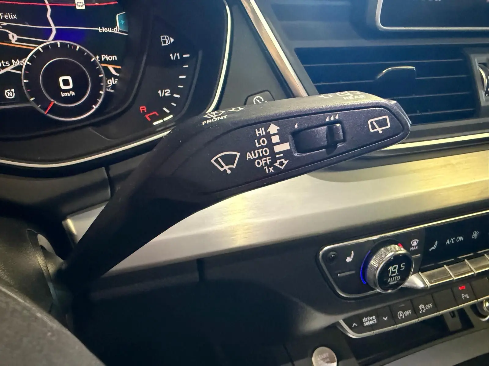 Gros plan sur la commande d’essuie-glace à gauche du volant dans l’habitacle gris d’un Audi Q5 Sportback 2019.
