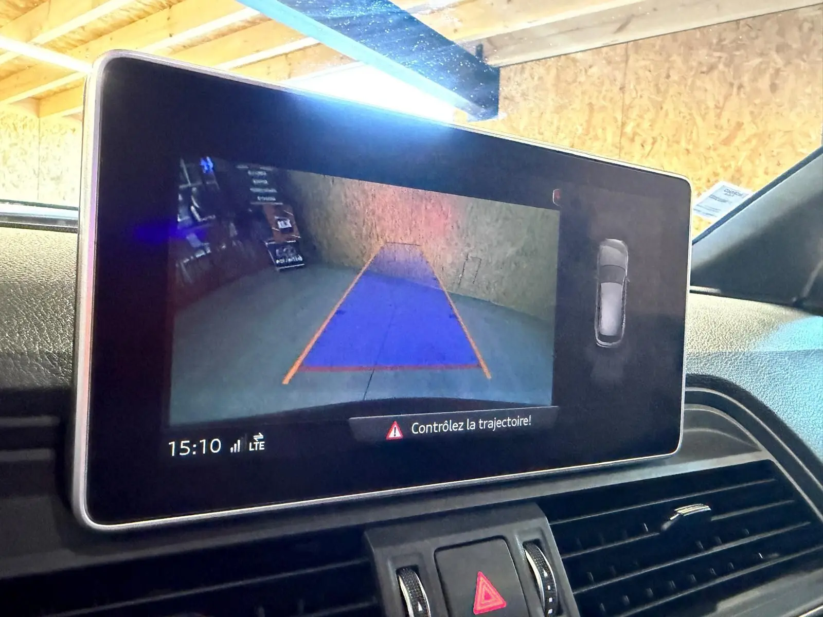 Écran intérieur de l’Audi Q5 Sportback 2019 montrant la caméra de recul avec guidage de trajectoire en bleu et orange.