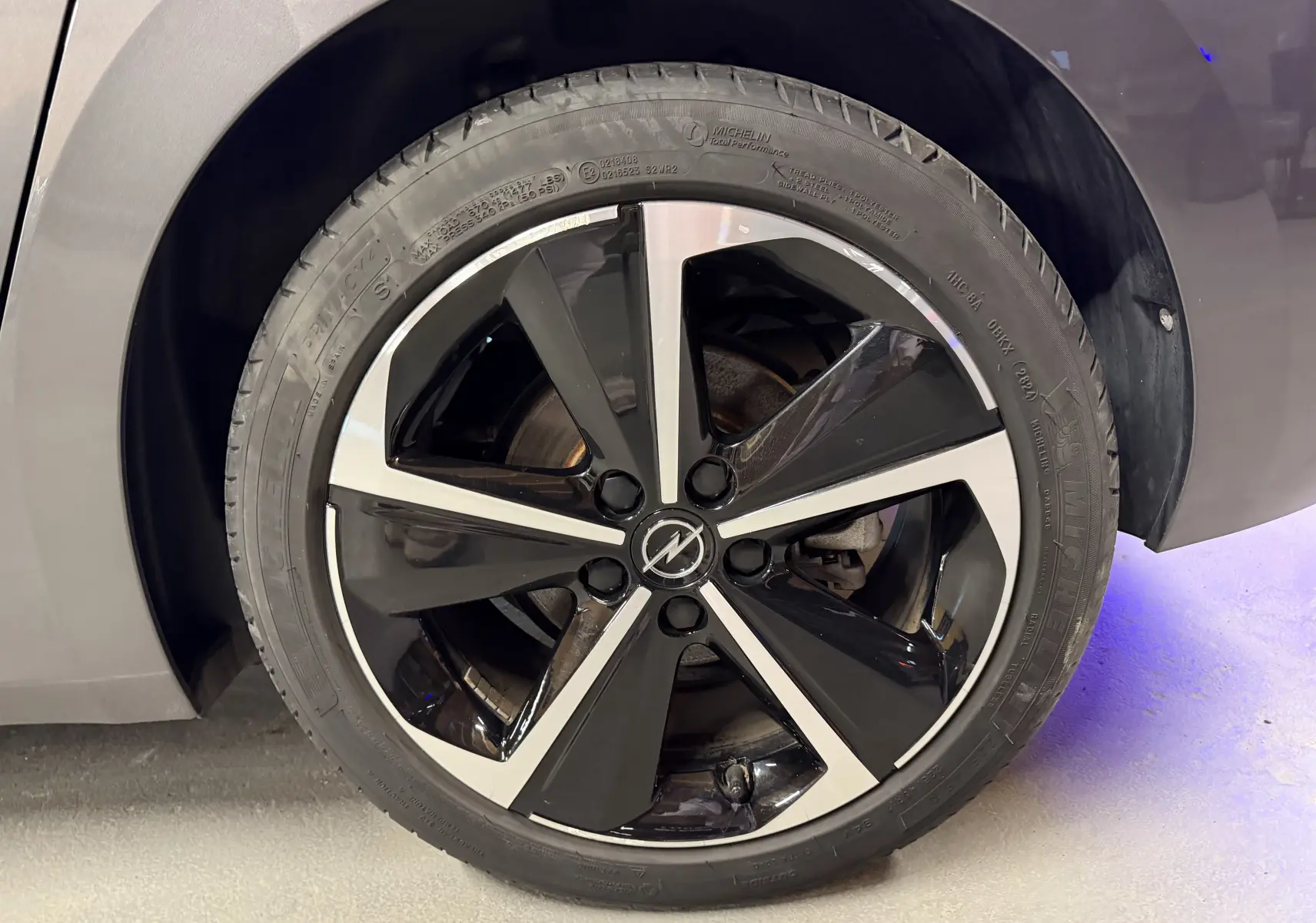 Gros plan sur la jante alliage 17'' diamantée noire et argentée de l'Opel Astra gris, côté avant droit.