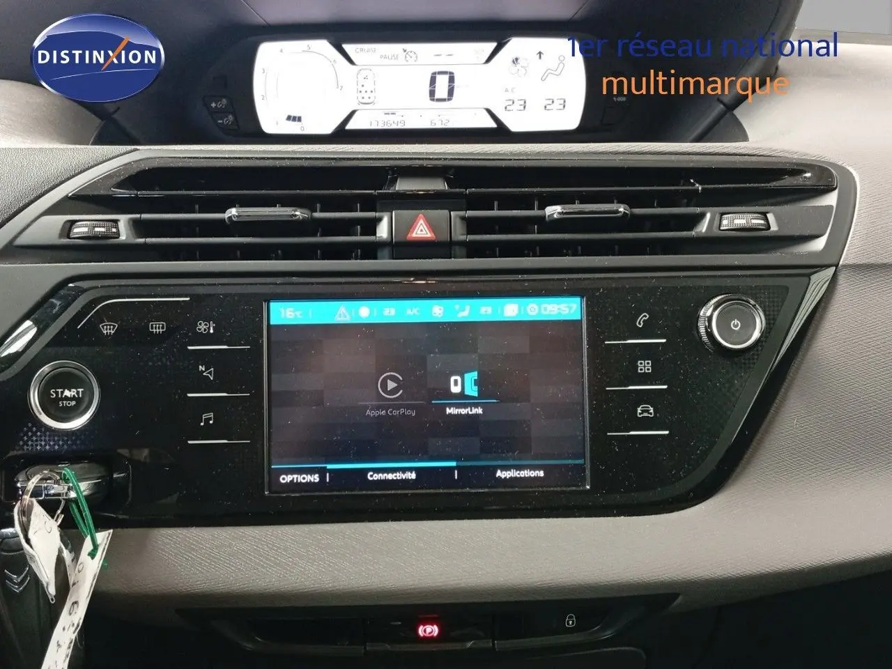 Tableau de bord du Citroën Grand C4 Picasso blanc, vue frontale centrée sur l'écran tactile et les commandes climatiques.