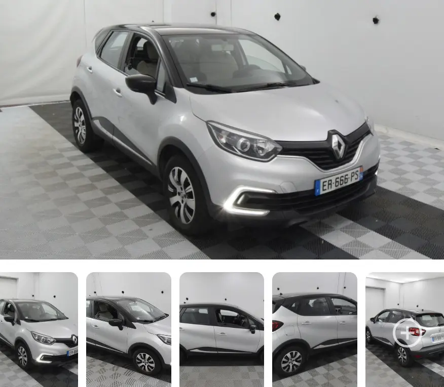 Renault Captur gris vue 3/4 avant droit, feux diurnes allumés, jantes aluminium et toit noir contrasté.
