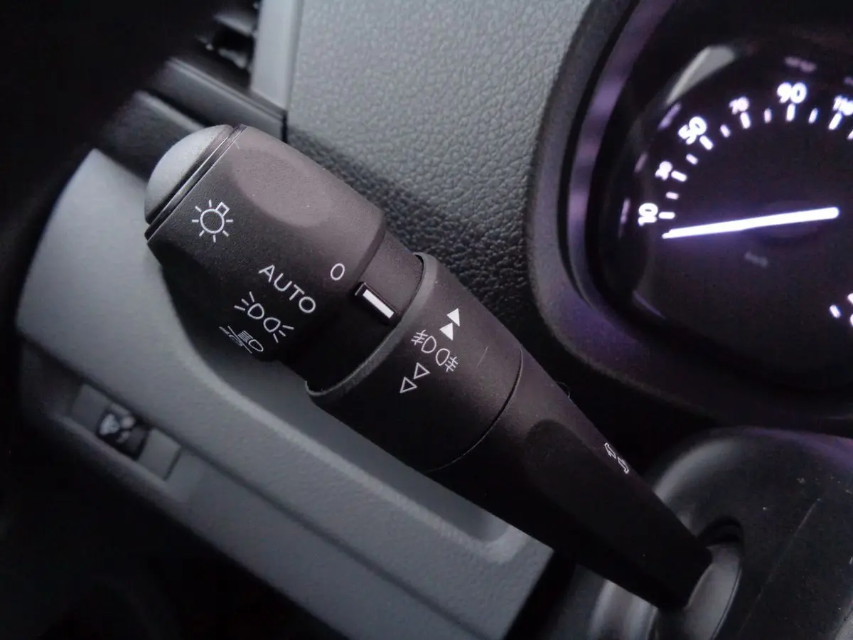 Gros plan sur la commande des phares et clignotants du tableau de bord du Fiat Scudo Fourgon blanc 2022.