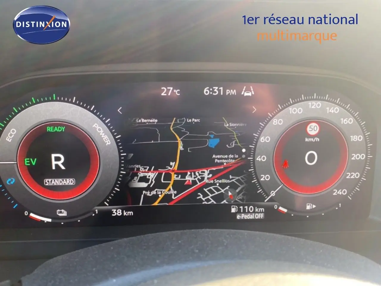Tableau de bord numérique du Nissan Juke 2025 affichant la navigation, la vitesse à 0 km/h et le mode hybride EV.