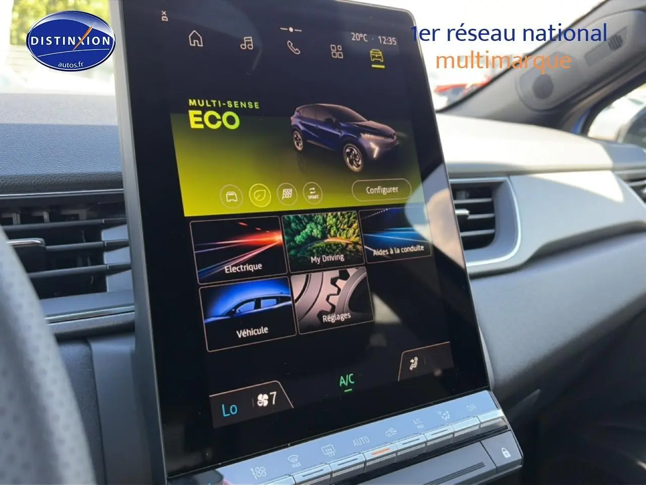 Écran tactile central du Renault Captur 2026 bleu iron, vue intérieure côté droit avec tableau de bord clair.