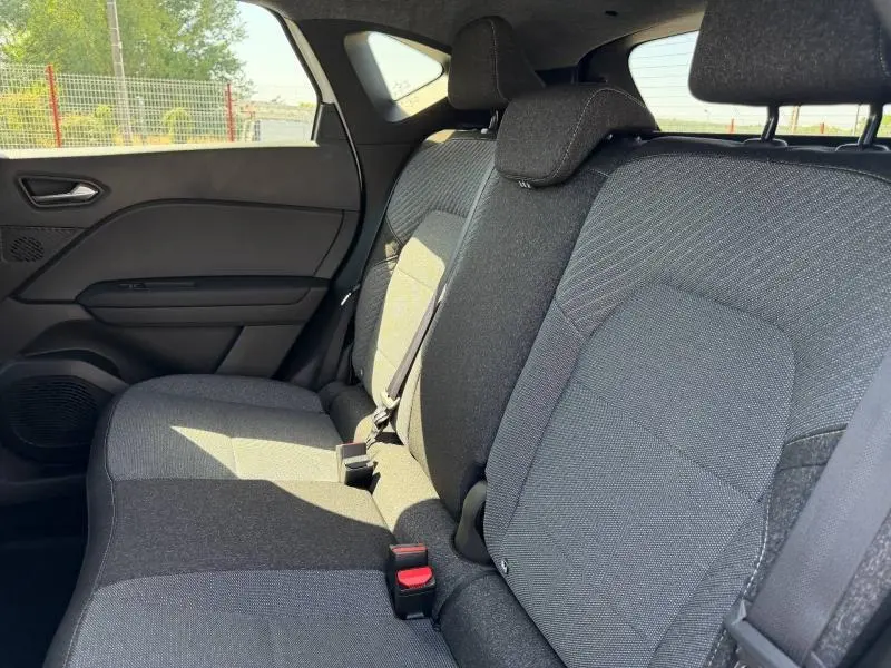 Vue latérale droite de la banquette arrière grise du Renault Captur 1.8 E-Tech hybride, avec appuie-têtes et ceintures visibles.