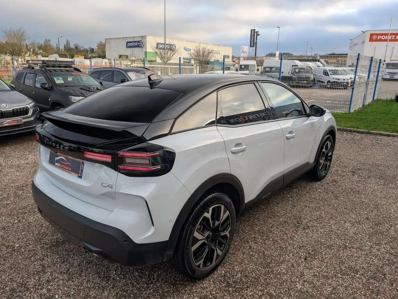 Citroën C4 blanc avec toit noir Perla Nera, vue 3/4 arrière côté droit, jantes alliage 18'' AMBER.