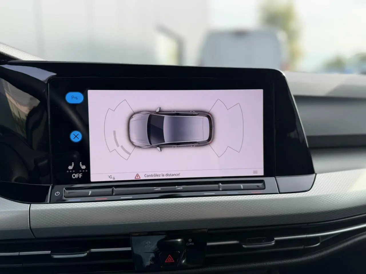 Écran tactile intérieur montrant la caméra de recul avec vue aérienne de la Volkswagen Golf 8 gris lunaire.
