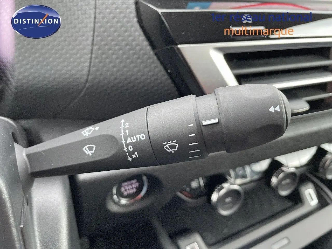 Gros plan sur la commande d’essuie-glace à gauche du tableau de bord d’une Citroën C4 gris platinium 2024.