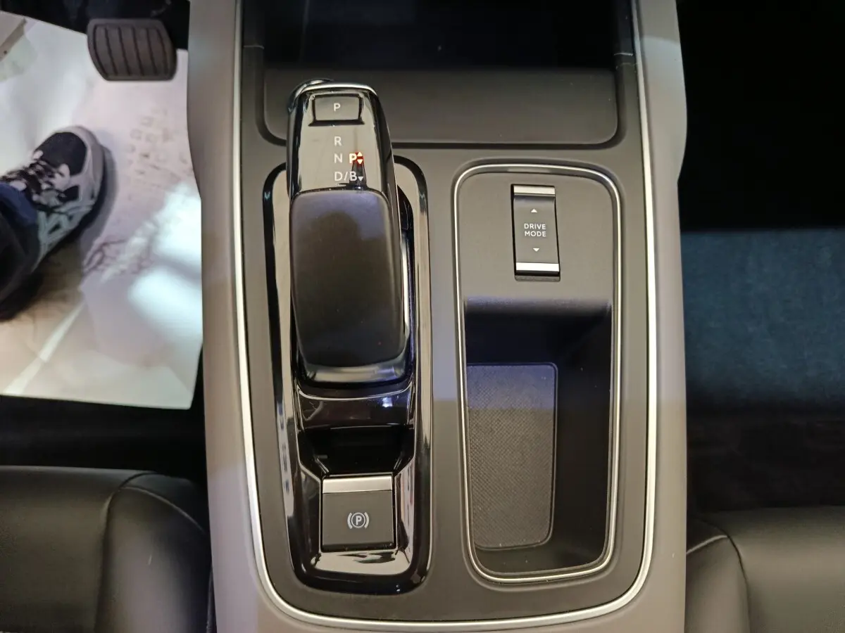 Vue rapprochée de la console centrale avec levier de vitesses et bouton Drive Mode du Citroën C5 Aircross Hybrid blanc.