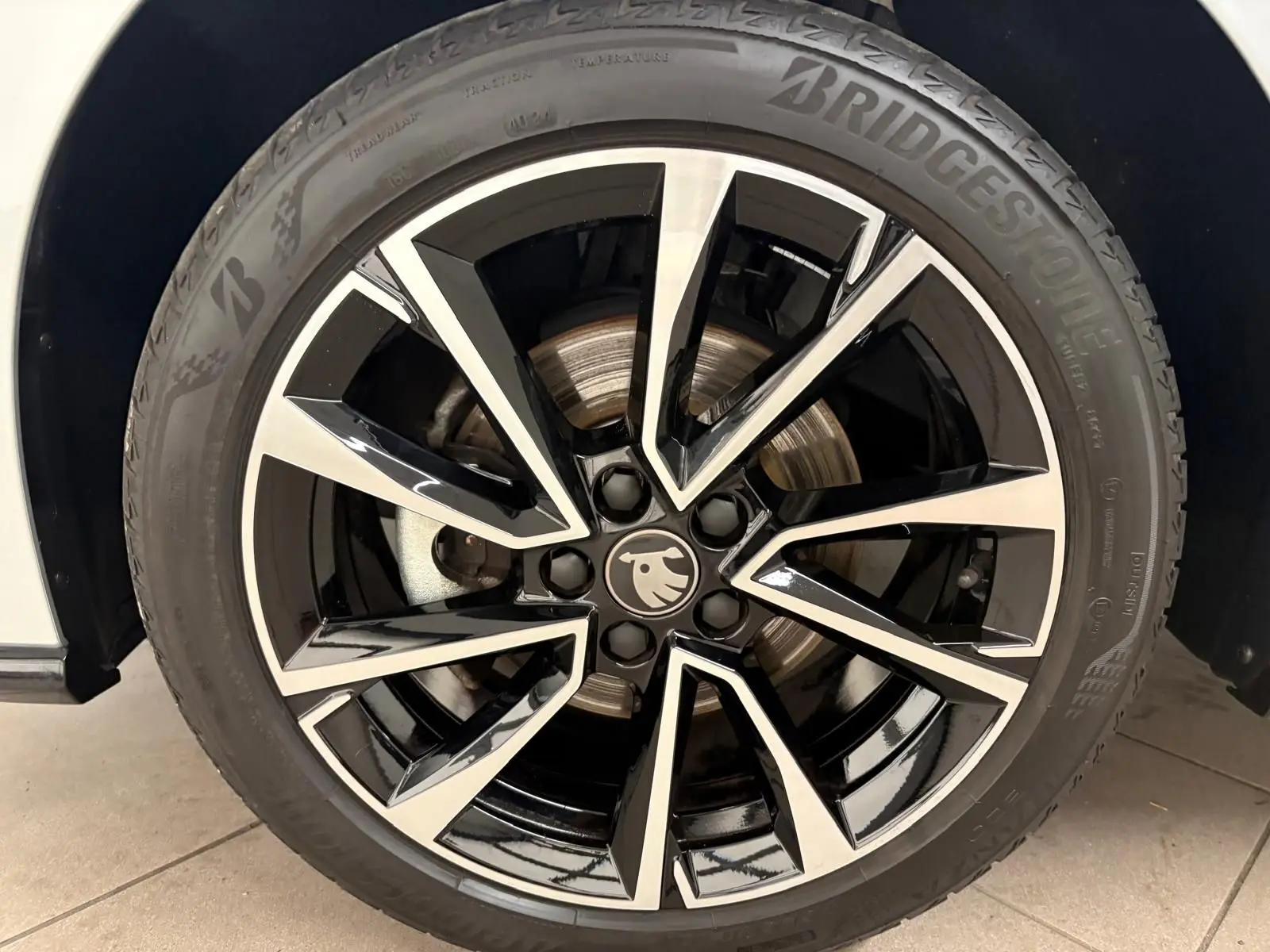 Gros plan sur la jante noire et argentée d'une Skoda Fabia 1.0 TSI 116 DSG7 Monte Carlo gris argent toit noir.
