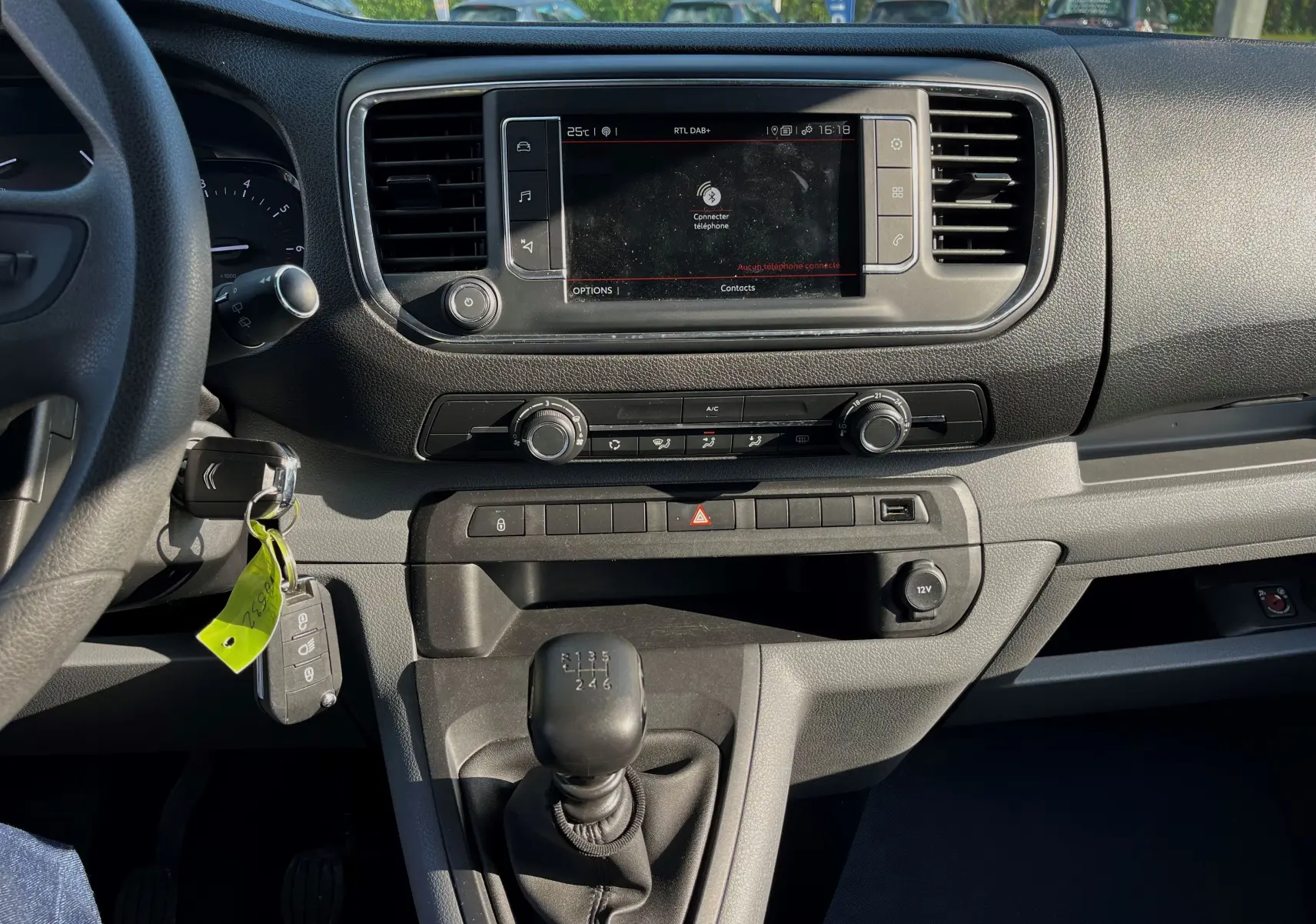Vue intérieure du tableau de bord du Citroën Jumpy Spacetourer 2022, avec écran tactile, climatisation et levier de vitesses manuel.