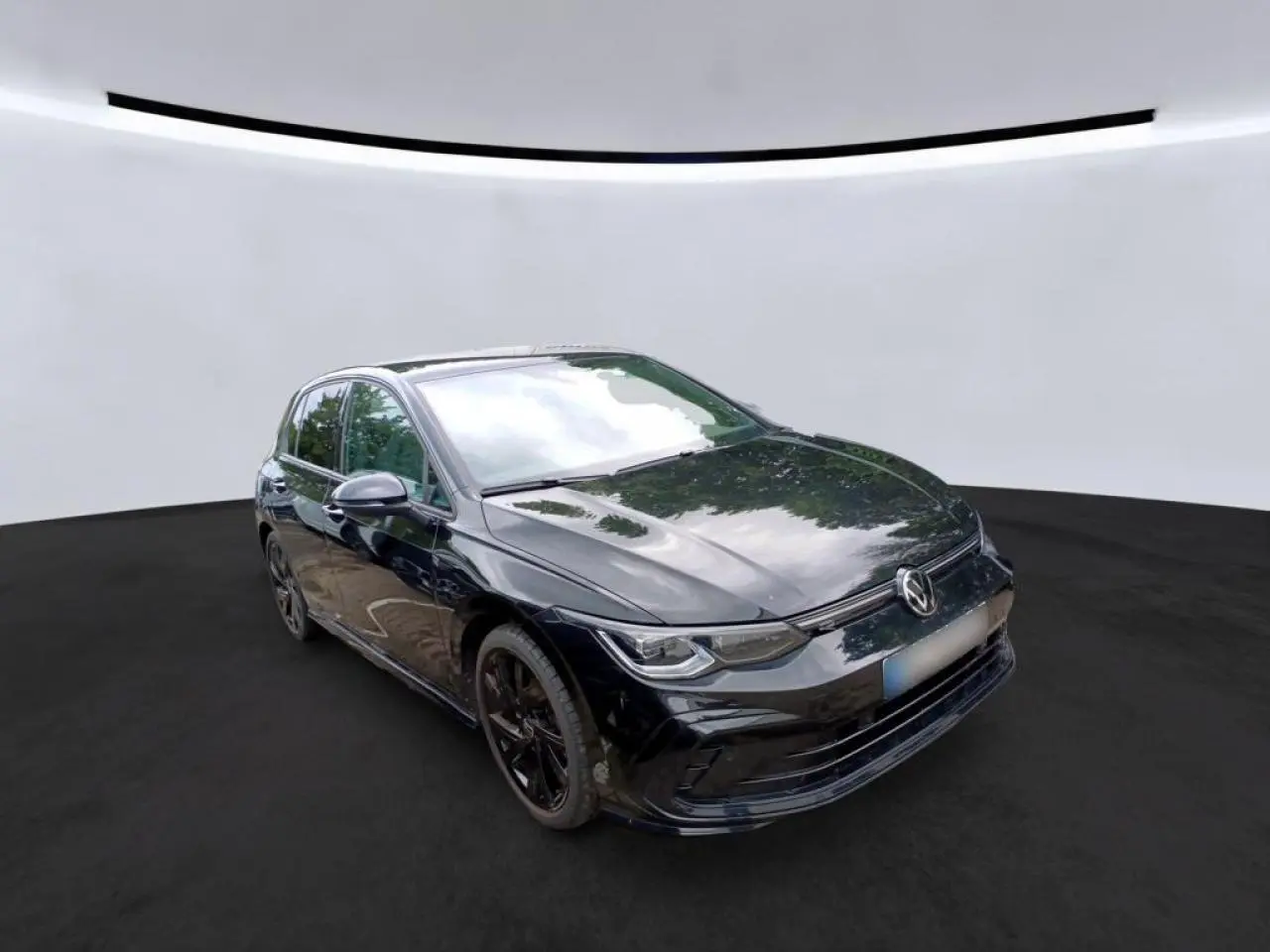 Volkswagen Golf 8 R-Line noire vue en 3/4 avant avec jantes noires et calandre spécifique R-Line.