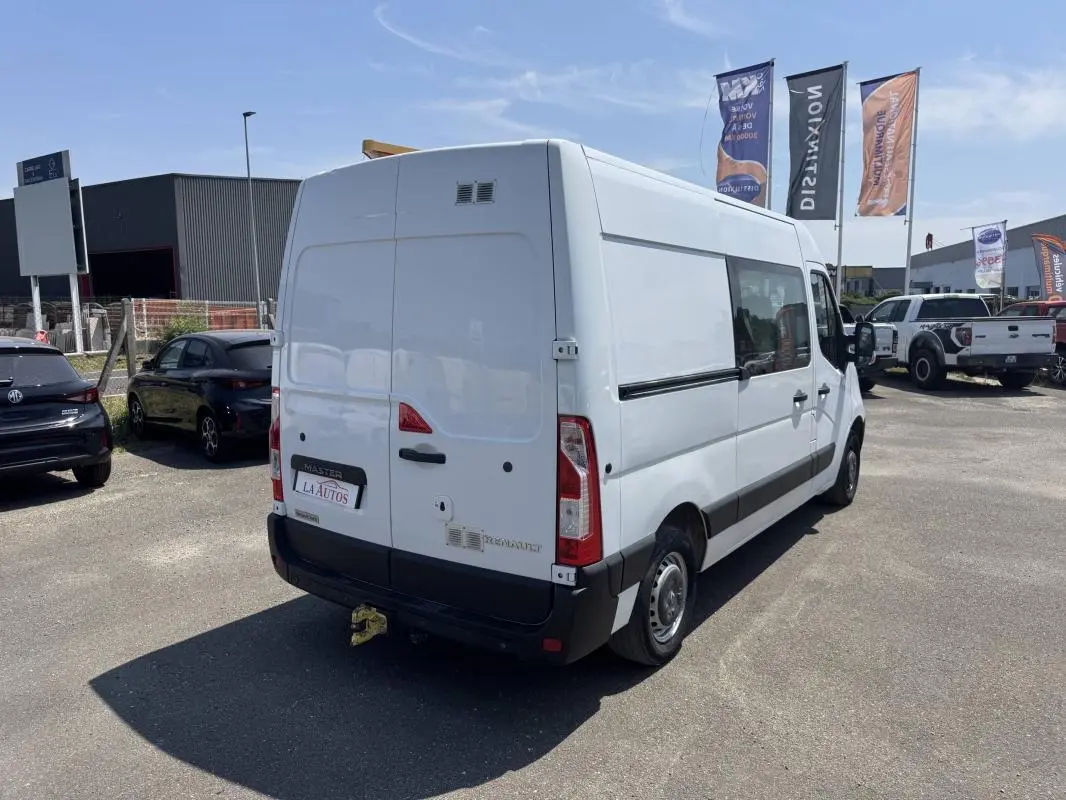 Vue 3/4 arrière droite d’un Renault Master blanc 2019, utilitaire avec hayon et attelage visible.