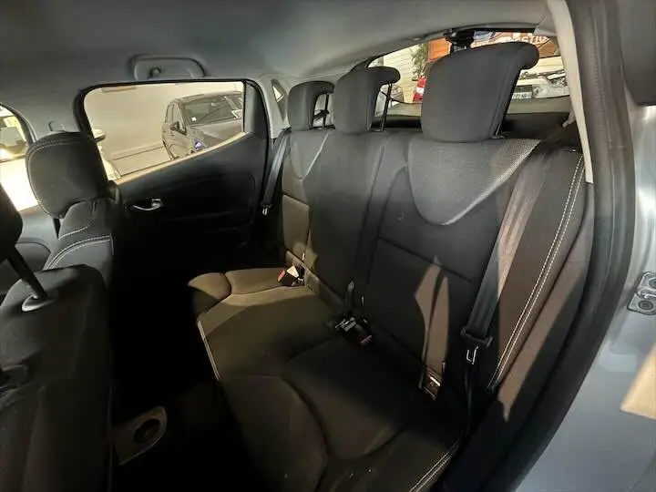 Vue intérieure côté droit des sièges arrière noirs de la Renault Clio IV gris argent de 2019 avec ceinture de sécurité visible.