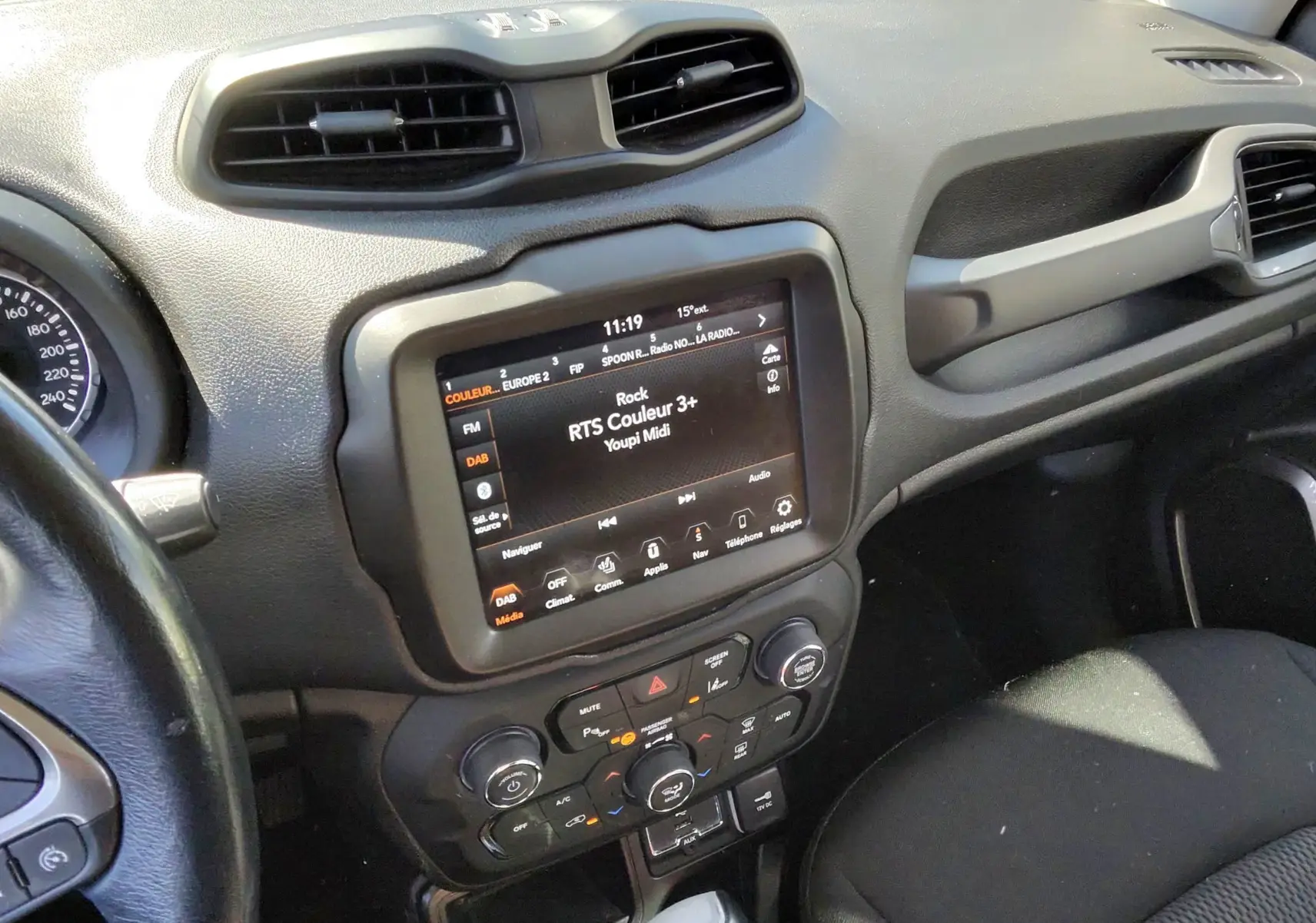 Vue intérieure du tableau de bord et console centrale d'une Jeep Renegade 2020, avec écran tactile et levier de boîte auto.